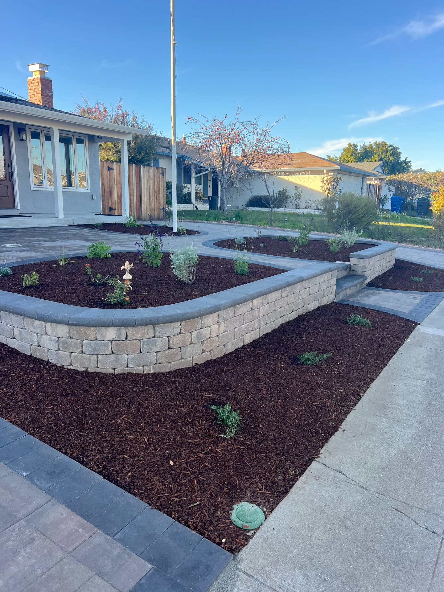 Tiered block retaining wall with capstone and steps