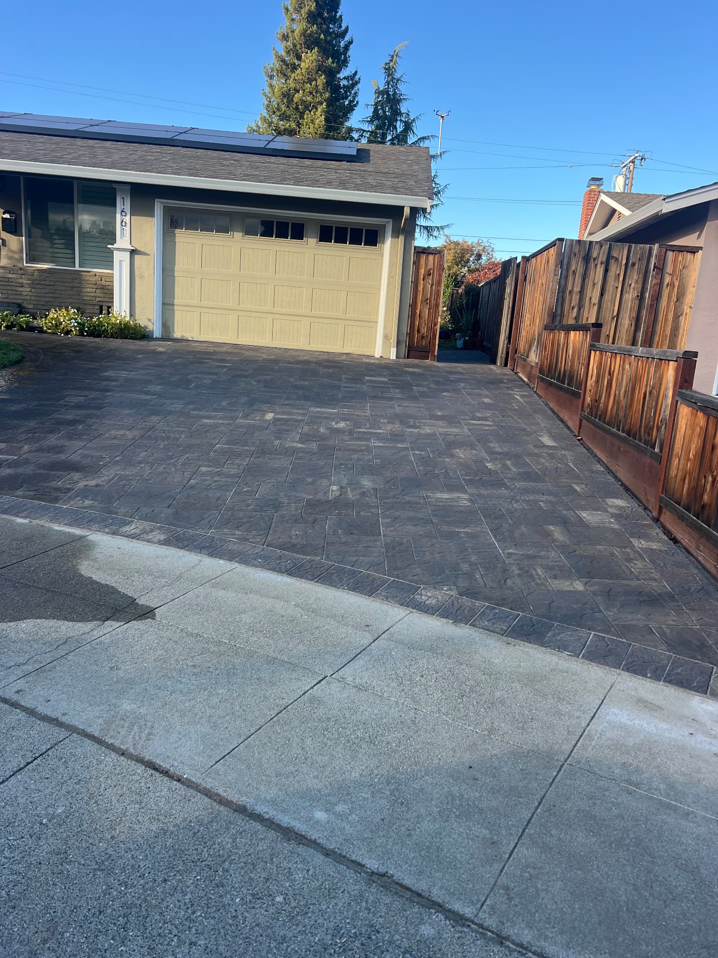 Paver driveway entry meeting the street apron