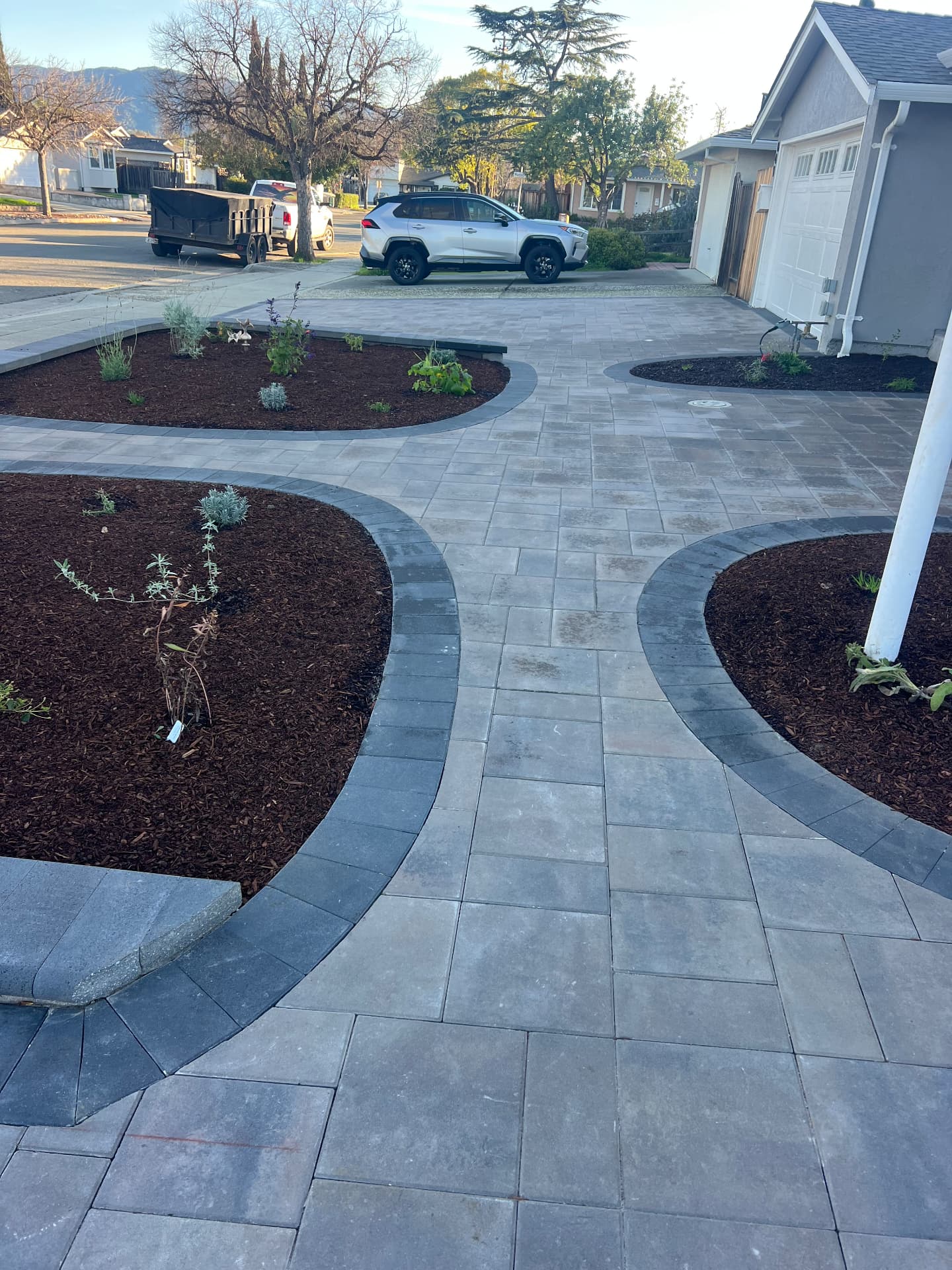 Paver walkway with charcoal border and mulched beds
